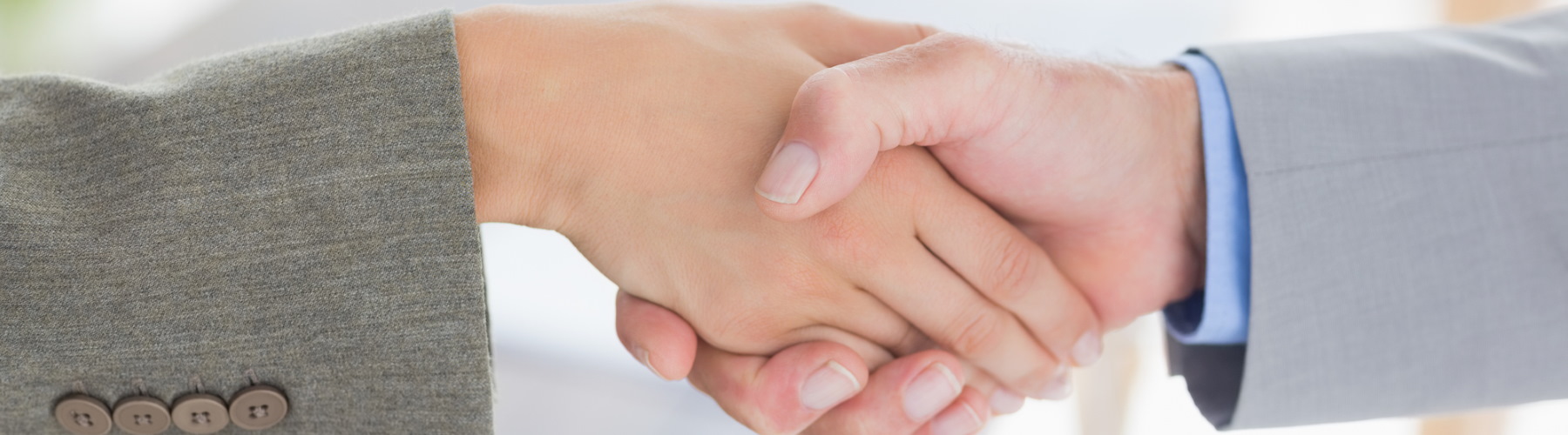 two people shaking hands close up